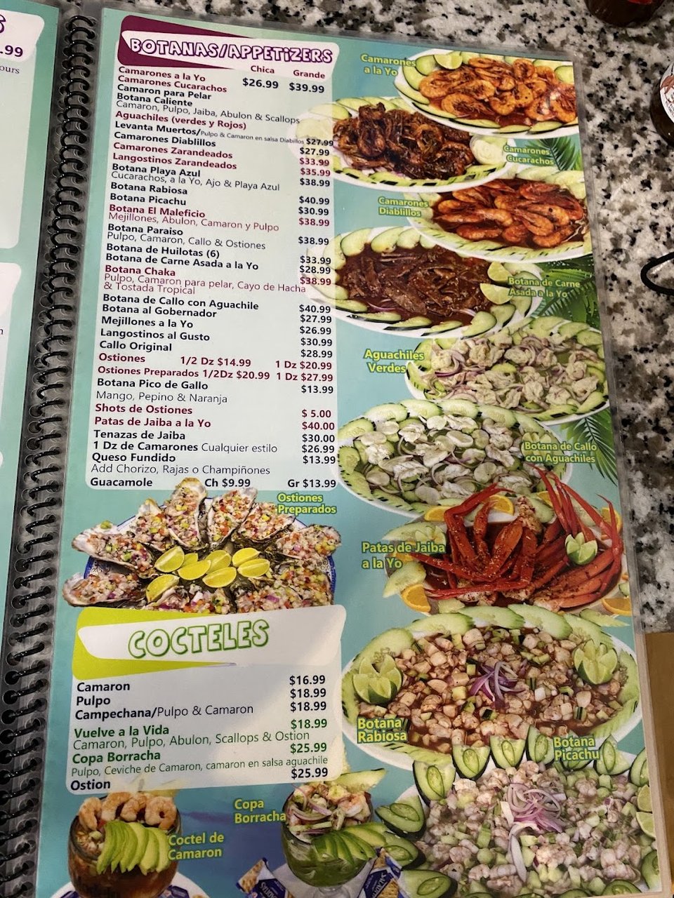 Printed menu featuring seafood dishes and cocktails.